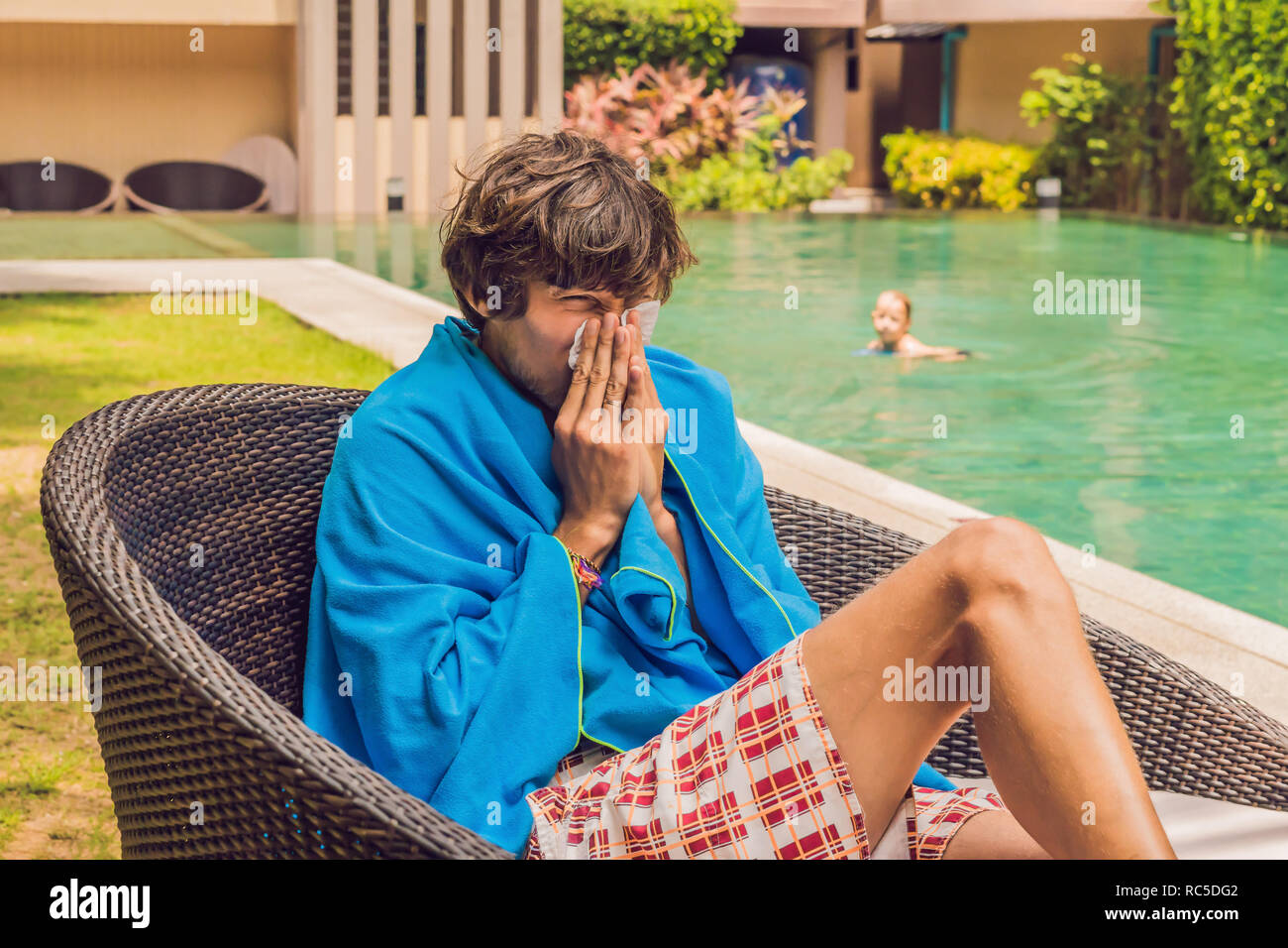 Sick man traveler. The man caught a cold on vacation, sits sad at the