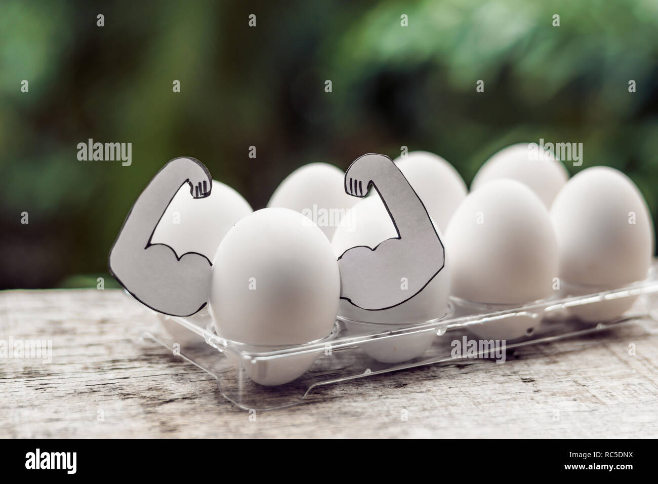 Egg with muscles, concept of egg protein, sports nutrition, diet for