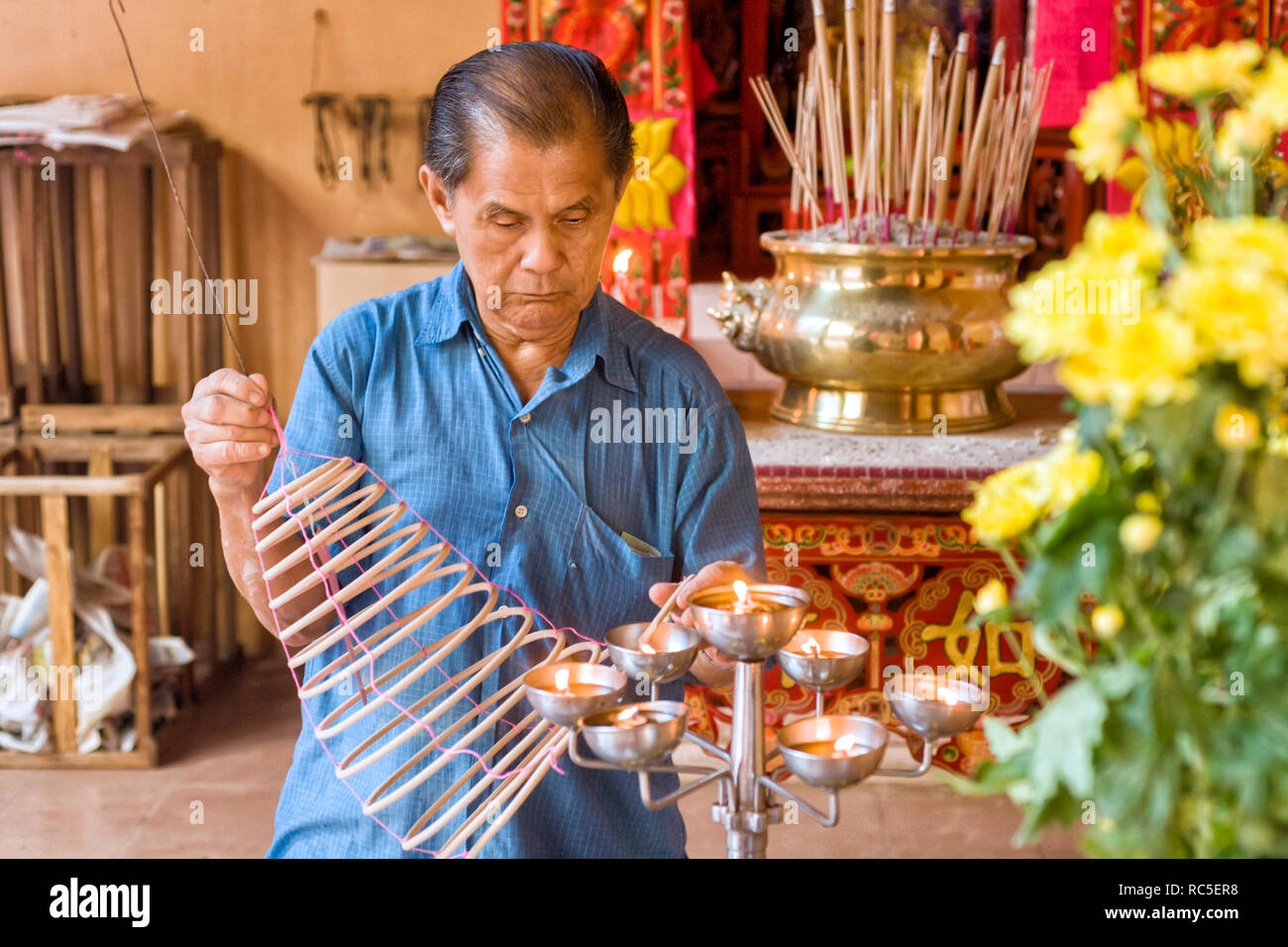 change the Spiral incense sticks that burn upward in the Guan Di Temple