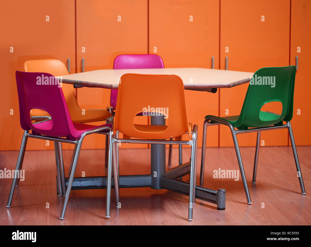 inside a school classroom of a kindergarten with small chairs and a