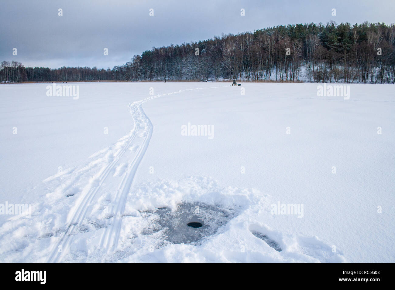 Fishing on a frozen lake in winter, hole Stock Photo Alamy