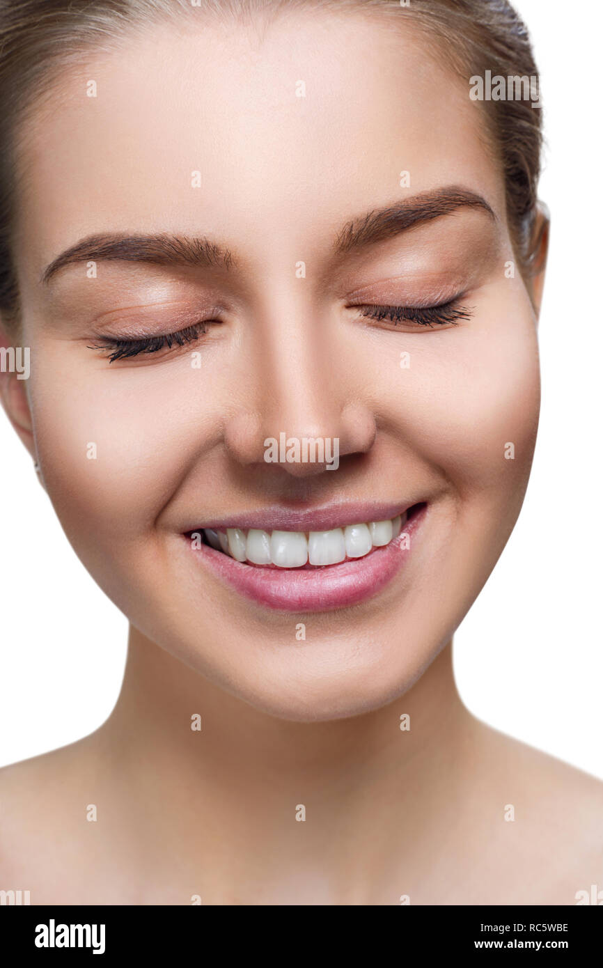 Young woman with toothy smile and closed eyes. Stock Photo