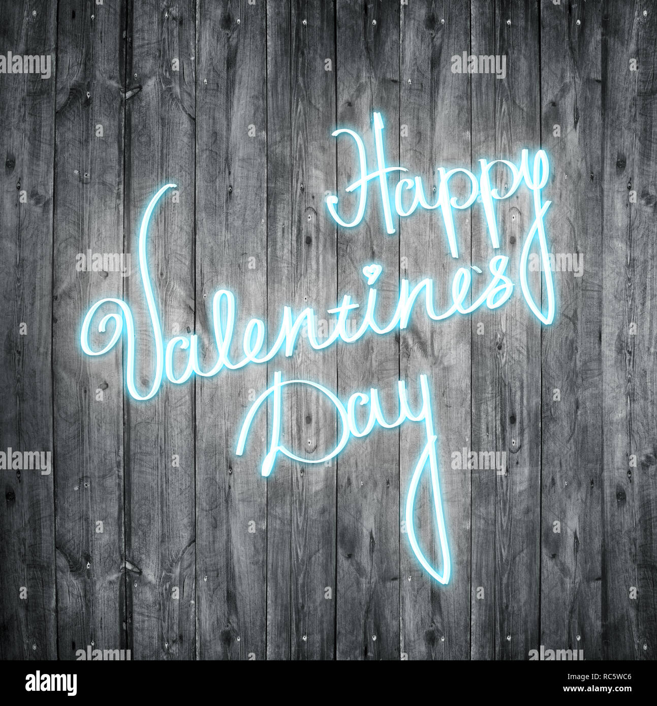 Happy valentines day neon sign over wooden background. Stock Photo