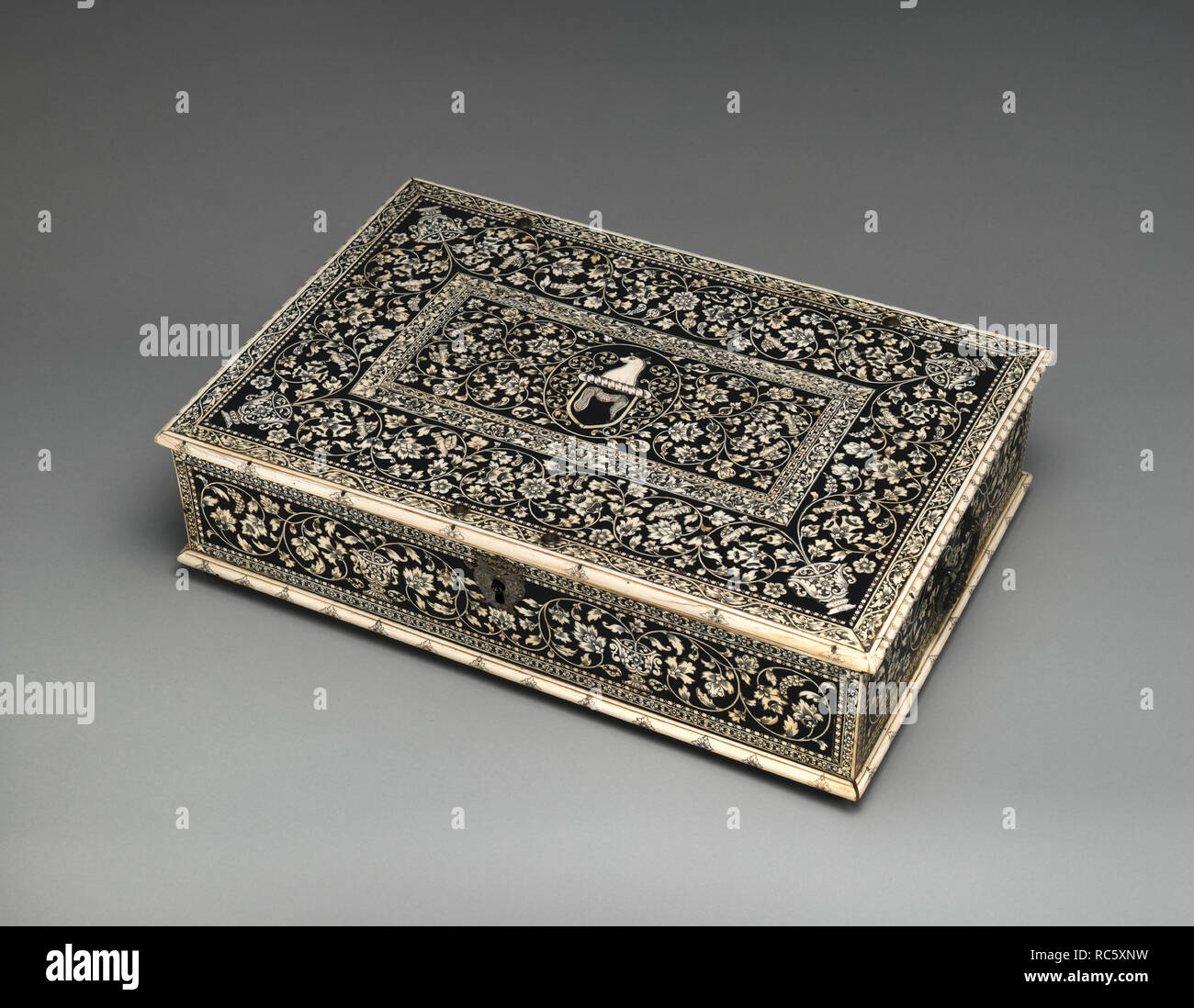 Casket. Culture: Indian, Vizagapatam. Dimensions: Overall (confirmed): 5 1/4 × 20 5/8 × 14 in. (13.3 × 52.4 × 35.6 cm). Date: ca. 1760-65.  Based on a European prototype but constructed from indigenous timber and densely decorated with ivory inlays displaying European ornament, this casket is an excellent example of an Anglo-Indian export piece. Writing boxes, rifles and gun boxes with European marquetry decoration are likely to have been used by Europeans. This particular casket is decorated with the crest of the Hastings family, presumably of Warren Hastings (1732-1818). Hastings had a brill Stock Photo