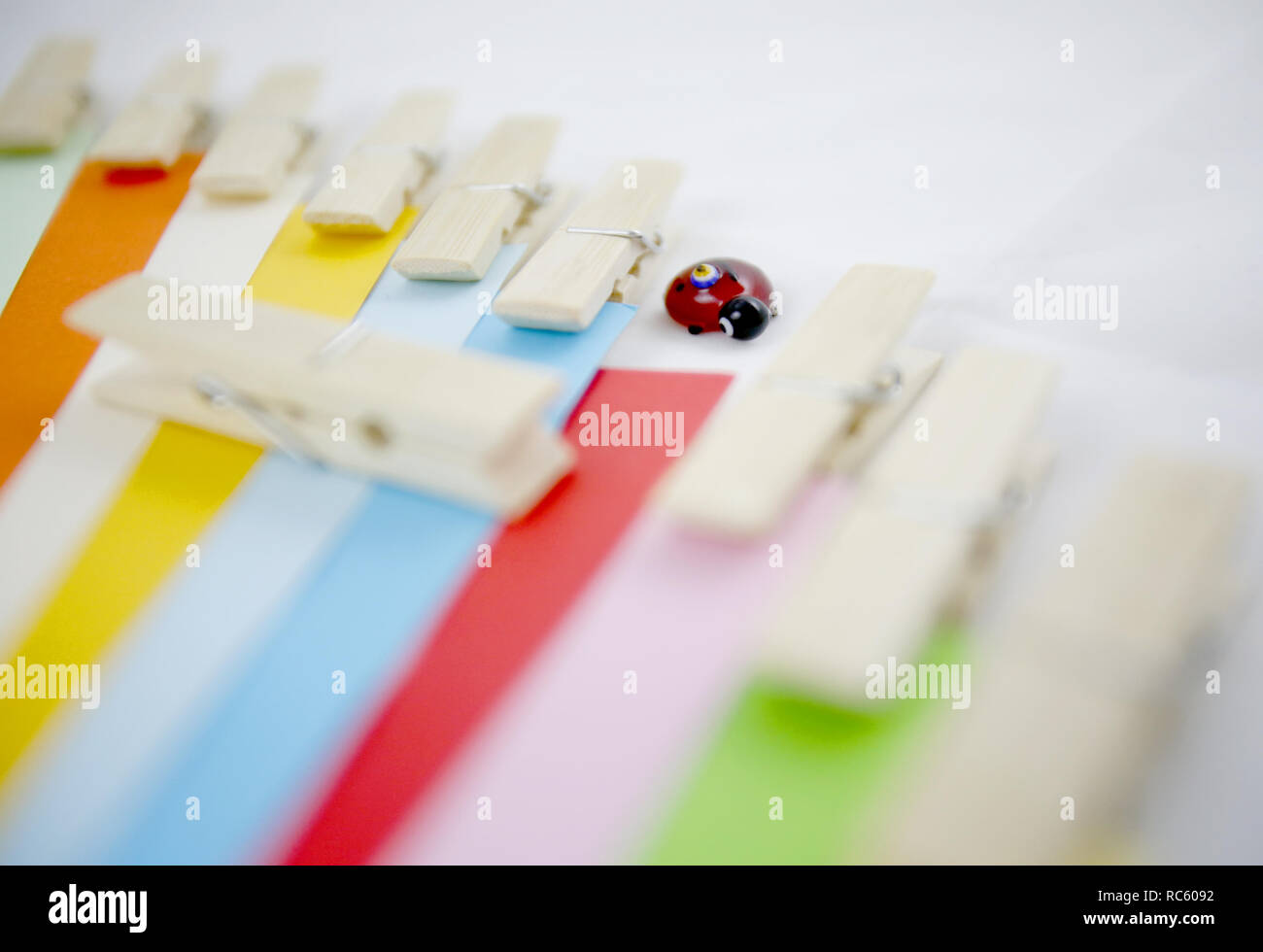 Wood latches and colourful paper and ladybug. Stock Photo