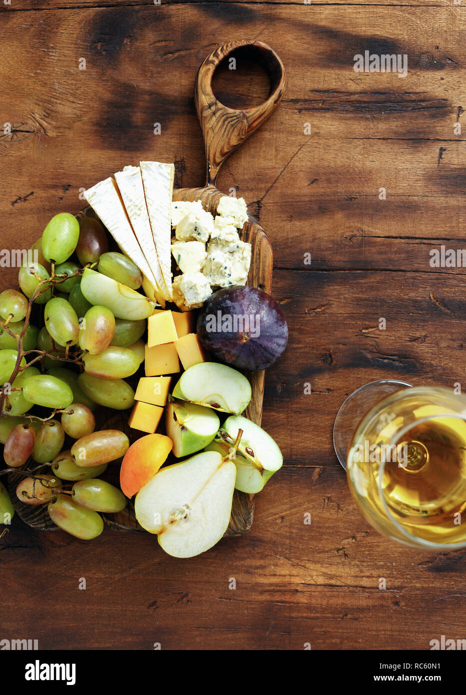 Set appetizers table and wine. Fruit and cheese on wooden board. Wine