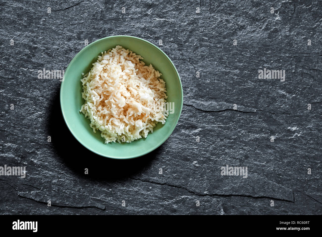 Handmade rice bowl on black shist with oblique light Stock Photo