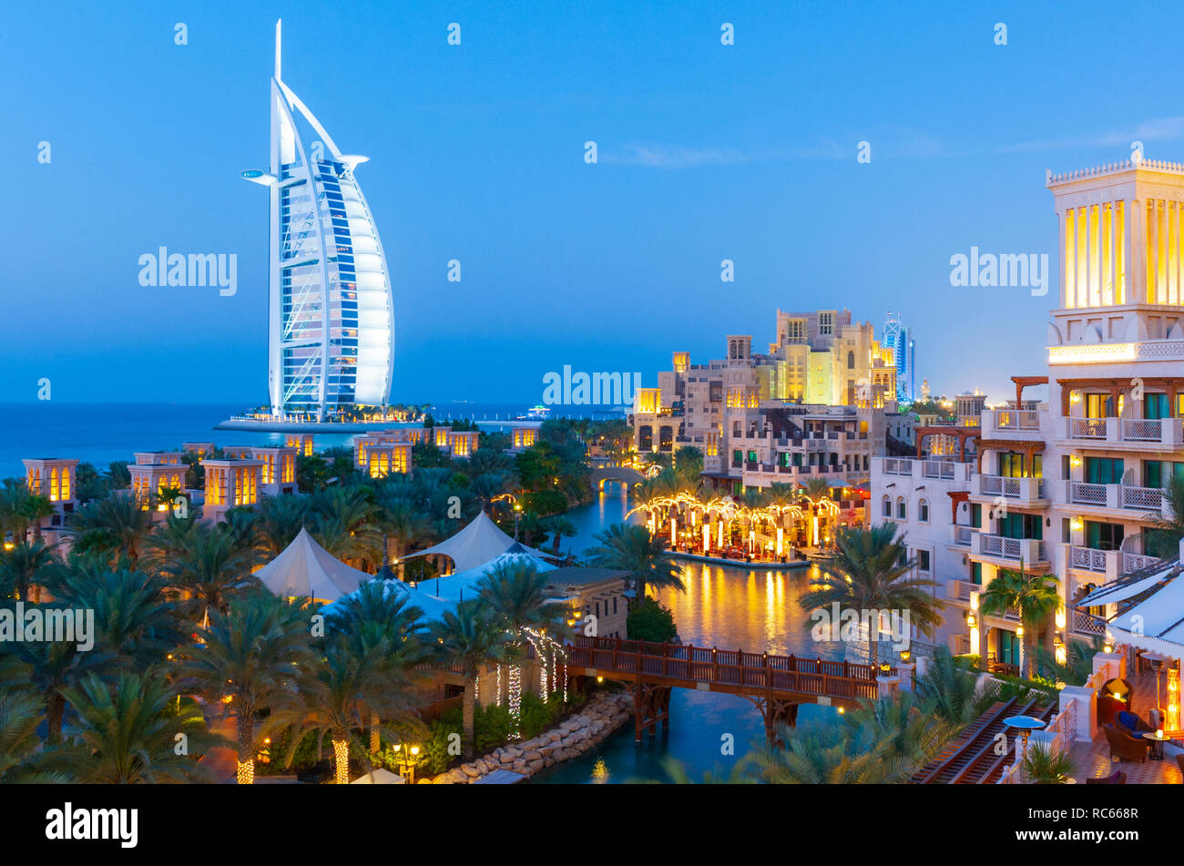 View of luxury resort hotels at  Madinat Jumeirah and Burj al Arab hotel to rear in Dubai in United Arab Emirates Stock Photo