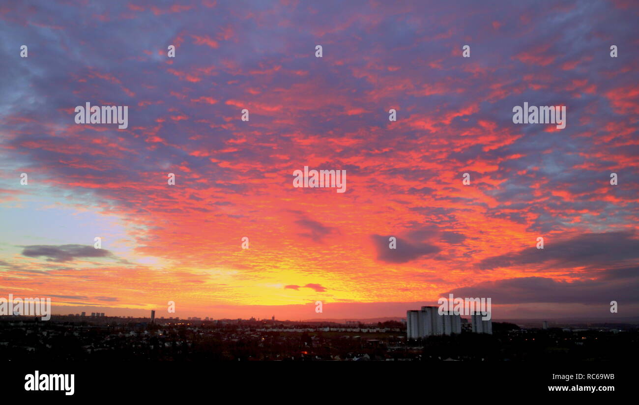 Glasgow, Scotland, UK, 14th January, 2019. UK Weather: Changeable  forecast with the threat of snow and another beast from the East saw a stunning  red sky in the morning warning  over the West end of the city  Credit Gerard Ferry/Alamy Live News Stock Photo