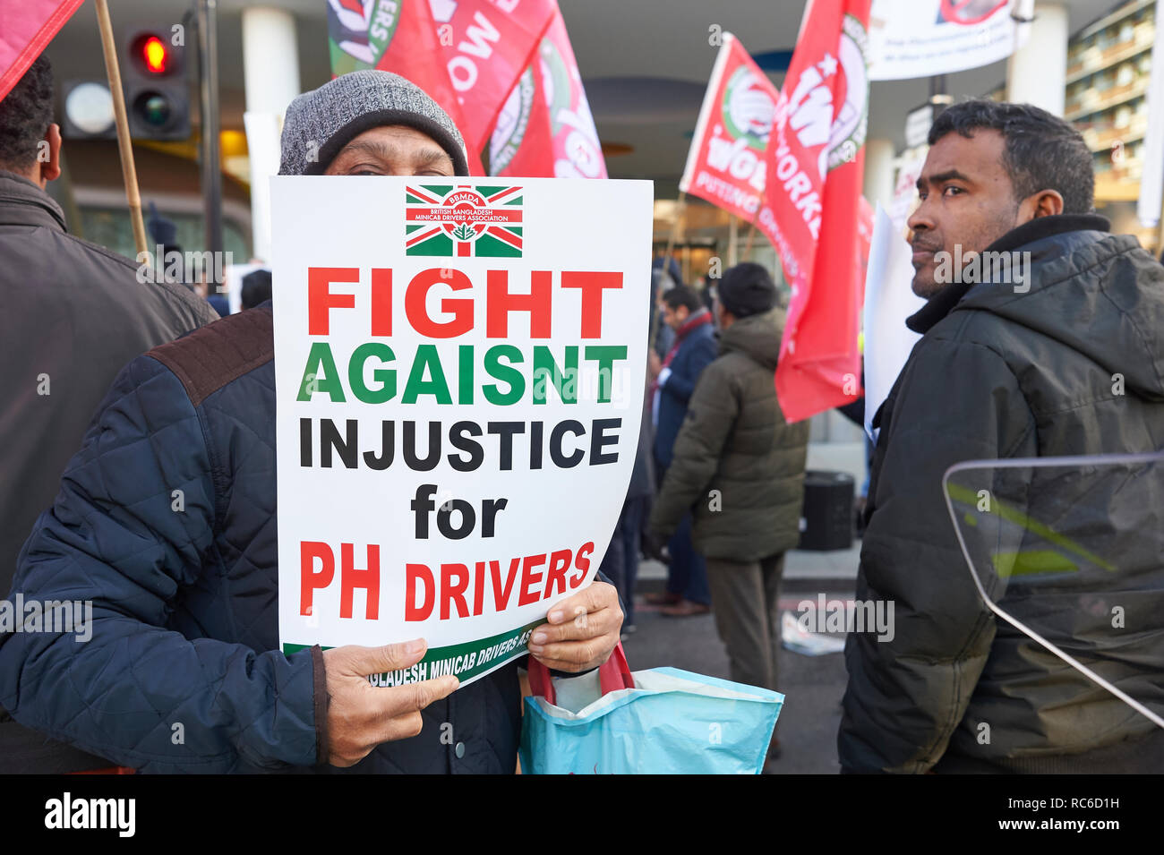 London, UK. 14th Jan 2019. Minicab drivers take part in a protest outside the offices of Transport for London, Southwark, organised by the Independent Workers Union of Great Britain's and United Private Hire Drivers branch following last months introduction of congestion charges for minicabs. Credit: Thomas Bowles/Alamy Live News Stock Photo