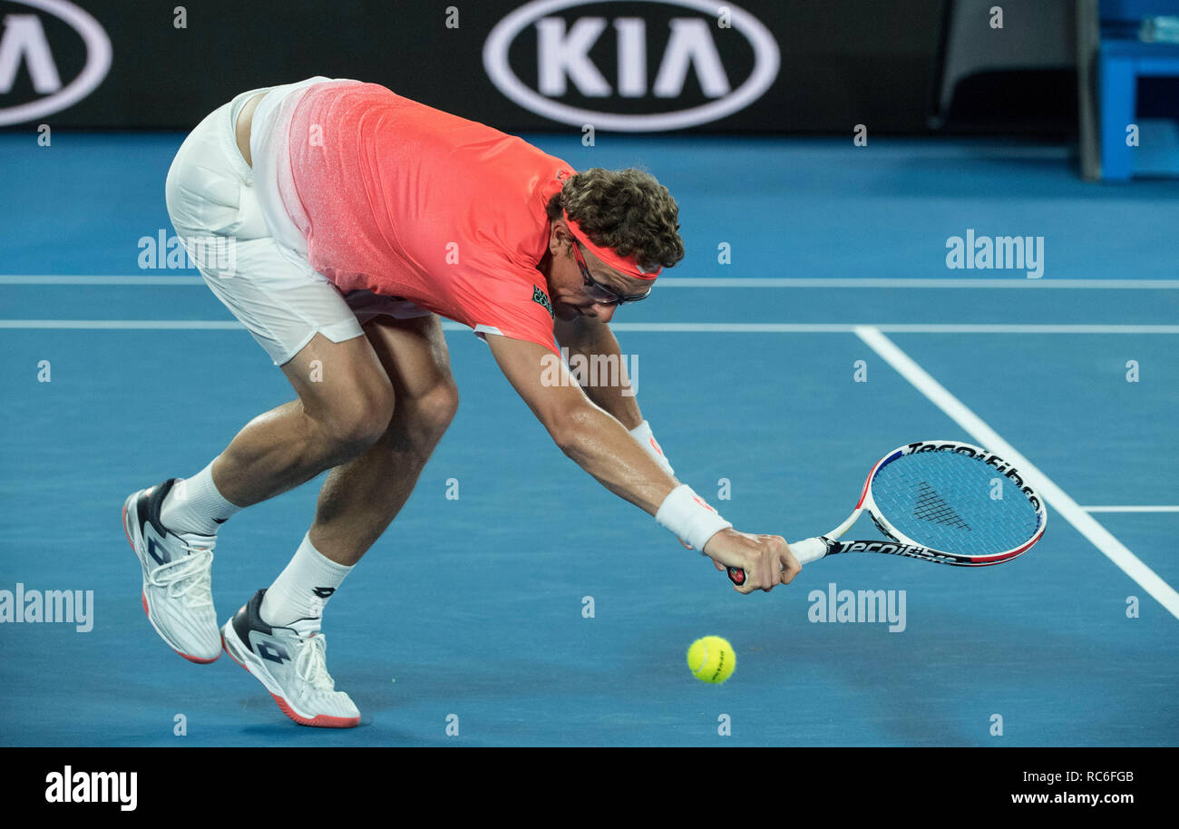 Melbourne, Australia. 14th Jan, 2019. Denis Istomin of Uzbekistan returns  the ball during the men's singles first round match between Roger Federer  of Switzerland and Denis Istomin of Uzbekistan at the 2019