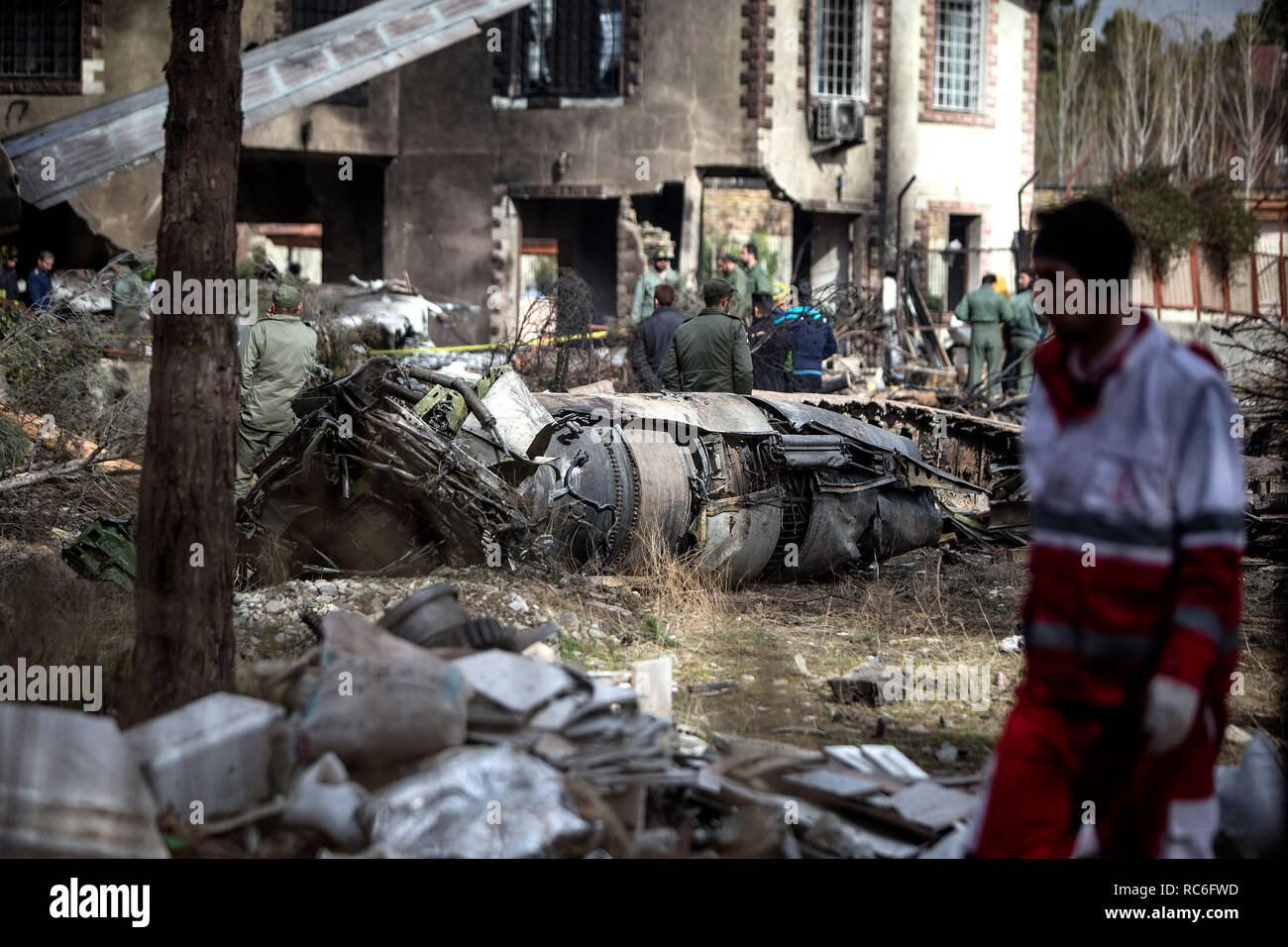 Karaj, Iran. 14th Jan, 2019. Rescuers work at the crash site of a Boeing 707 plane in Karaj, Iran, Jan. 14, 2019. At least 15 people were killed on Monday in the crash. Credit: Ahmad Halabisaz/Xinhua/Alamy Live News Stock Photo