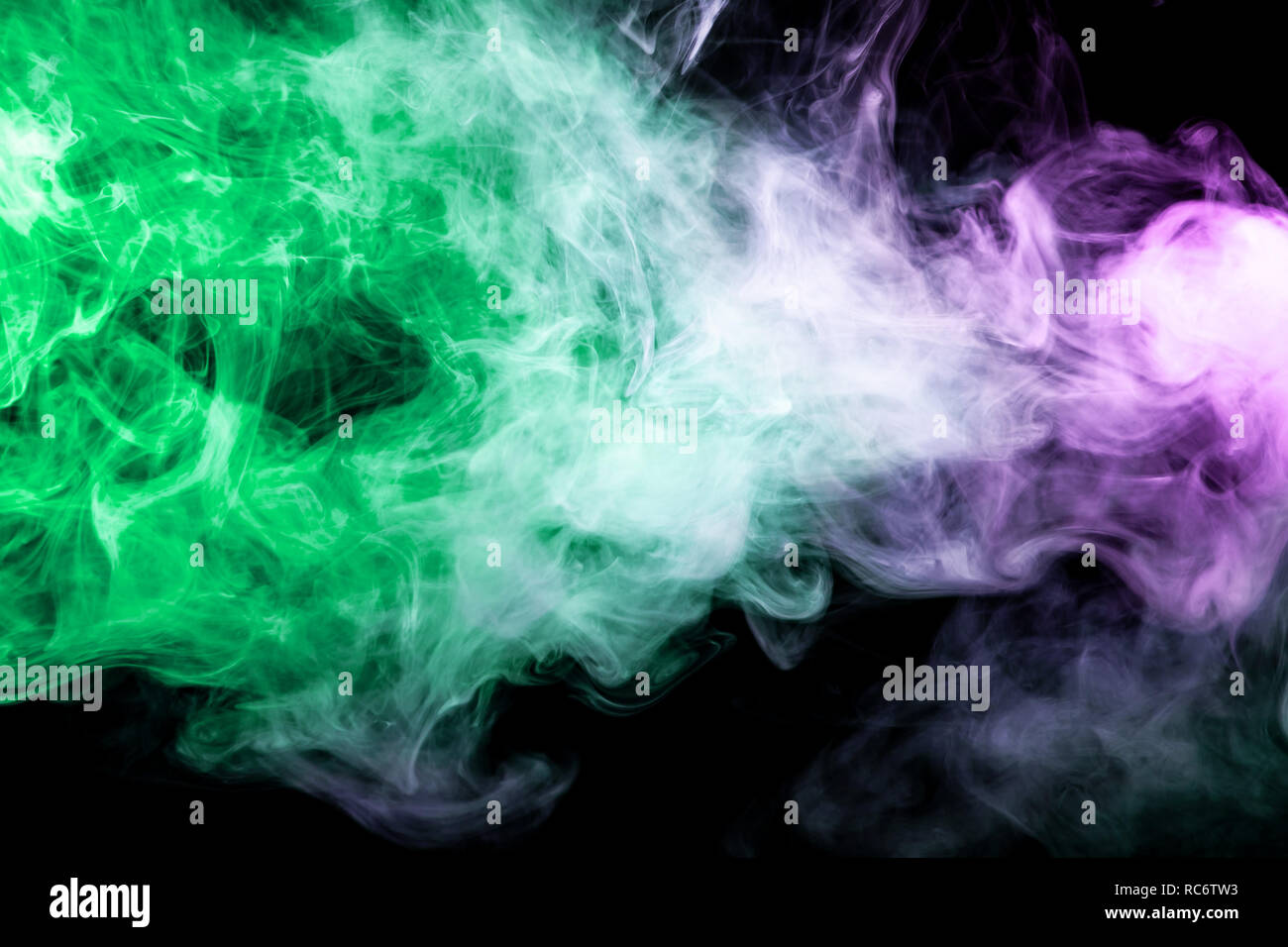 Thick green and purple smoke on a black isolated background. Background