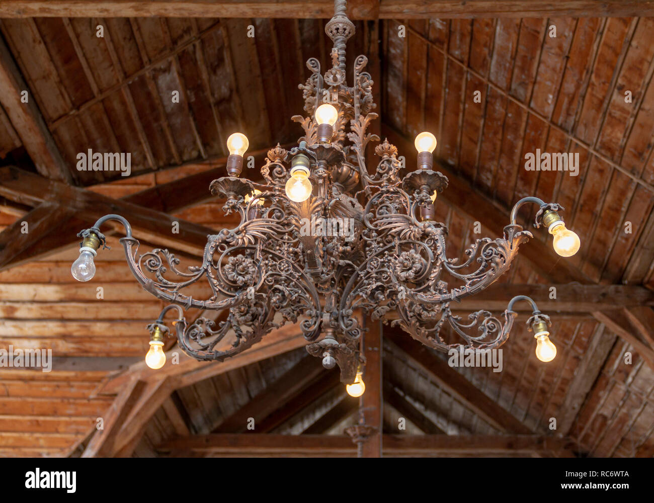 historic chandelier in rural wooden ambiance Stock Photo