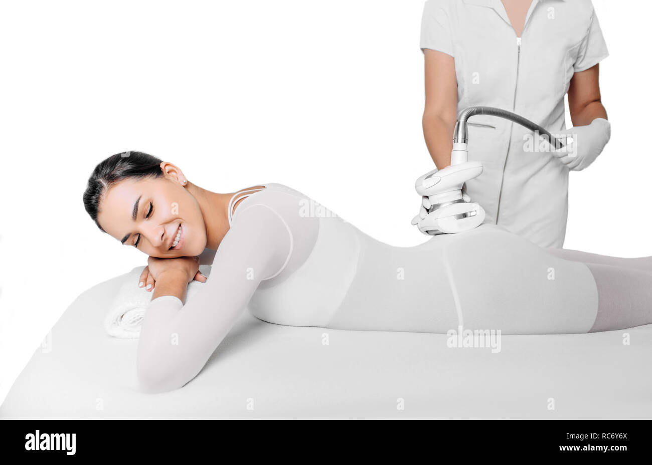 Beautiful woman getting beauty therapy against cellulite with LPG machine on her body on white background Stock Photo