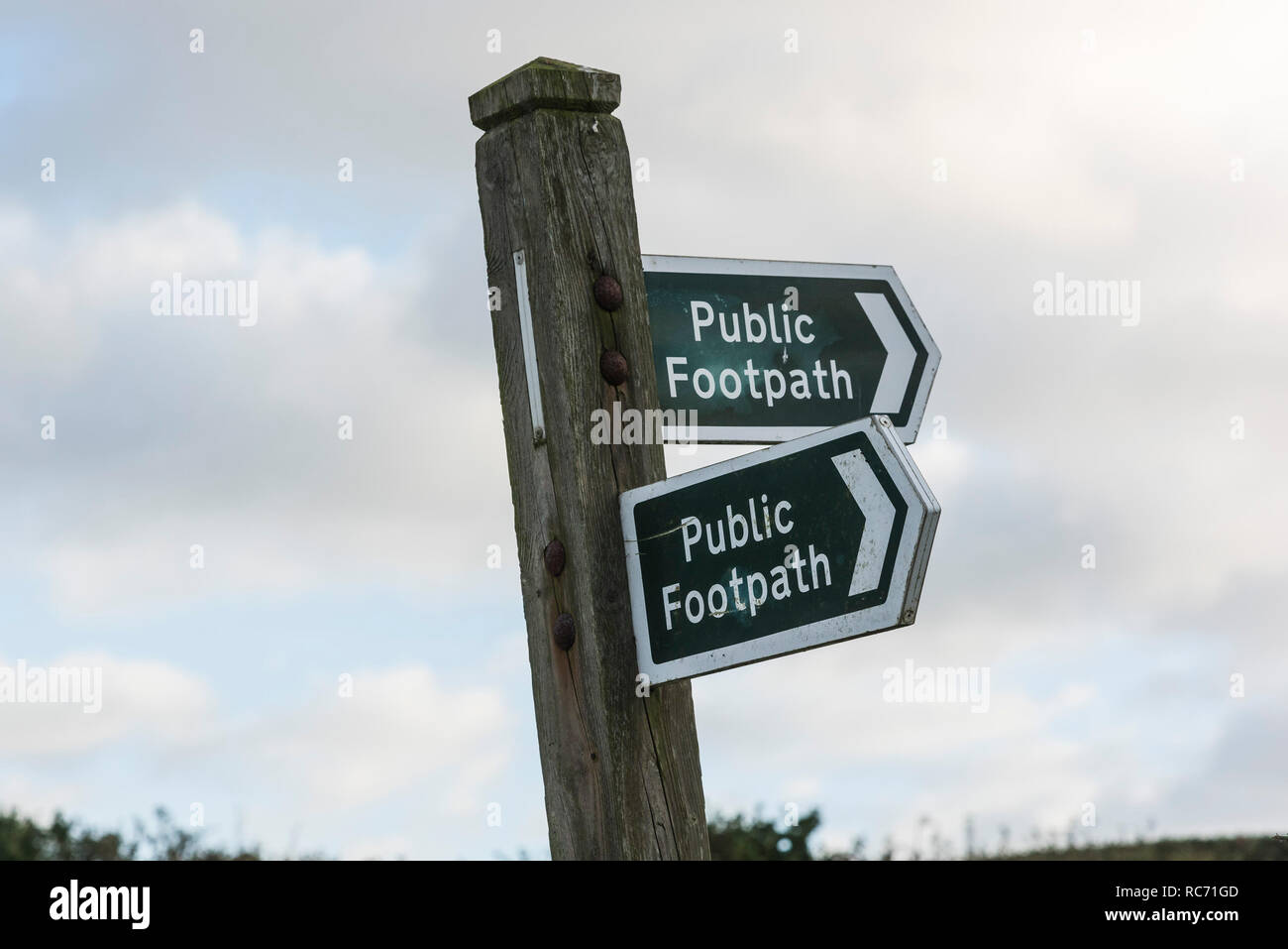 A signpost giving direction to public footpaths. Stock Photo