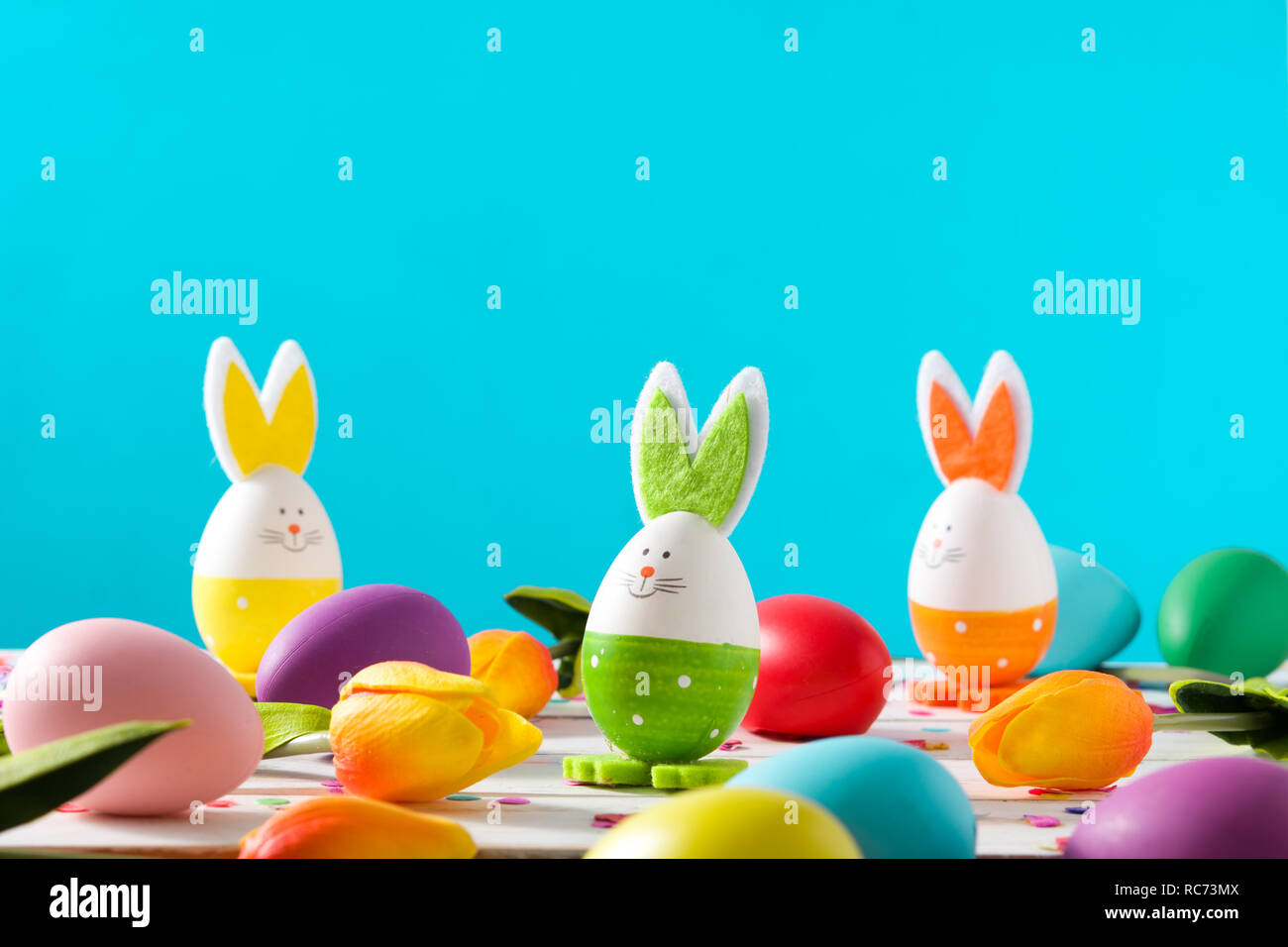 Easter holidays concept with easter eggs and rabbits on blue background Stock Photo