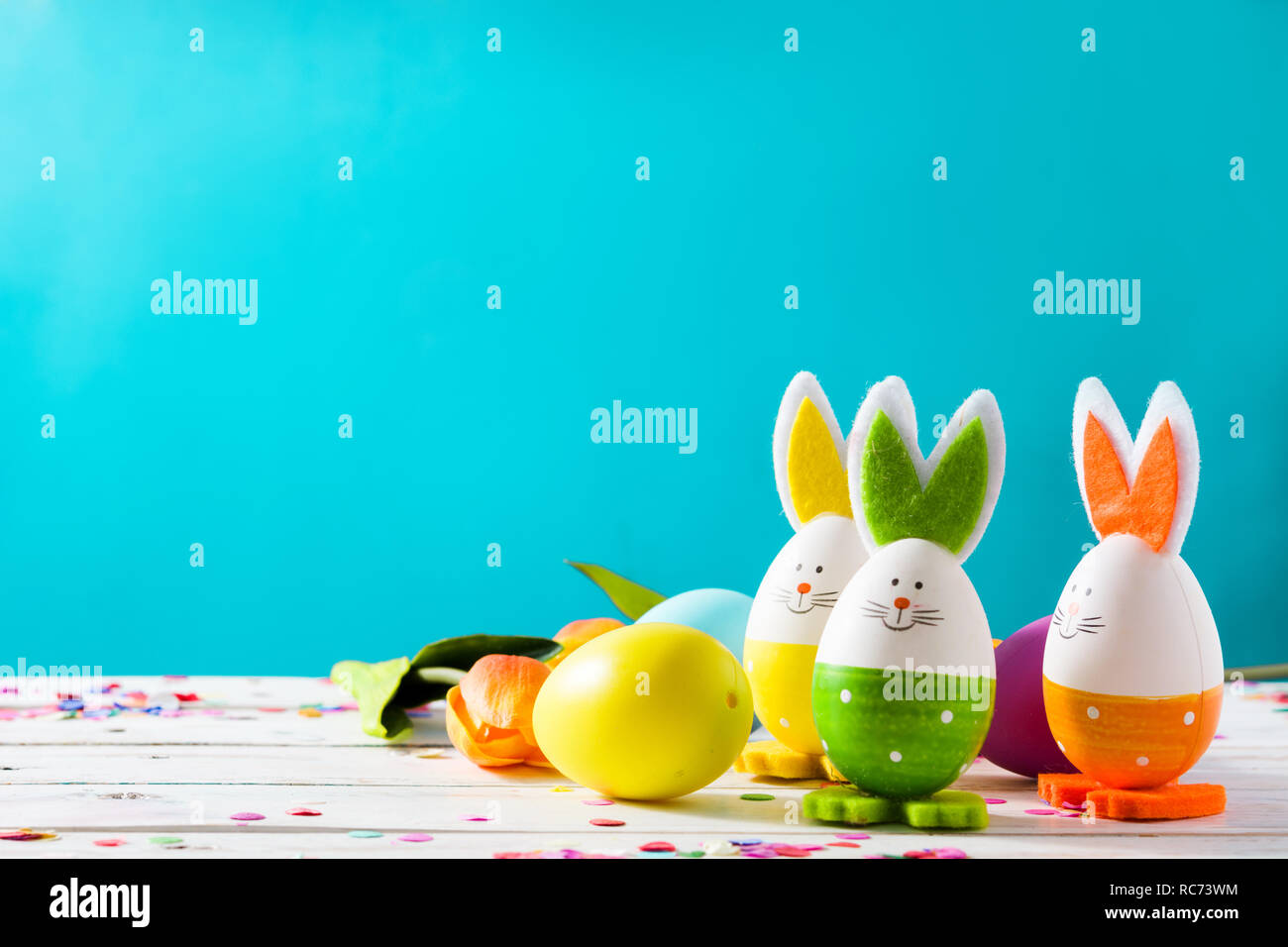 Easter holidays concept with easter eggs and rabbits on blue background Stock Photo