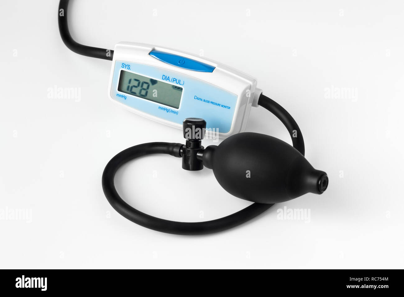 digital blood pressure monitor with a pear on a white background Stock Photo