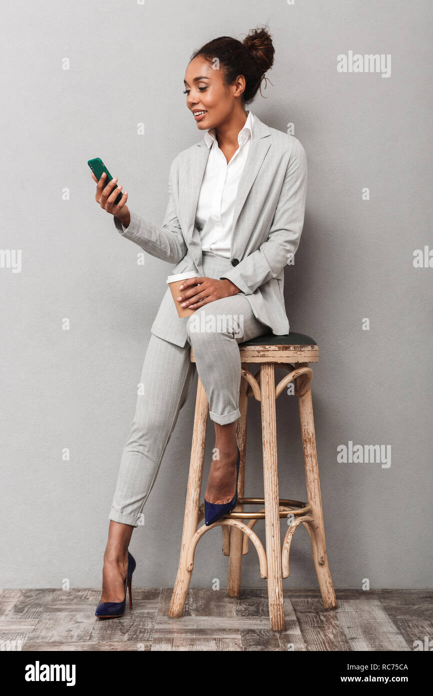Full length portrait of a confident african business woman wearing suit ...
