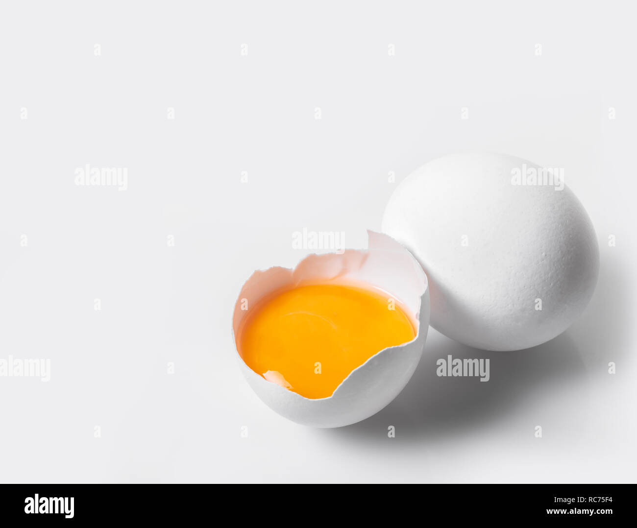 broken and whole chicken eggs on white isolated background Stock Photo ...