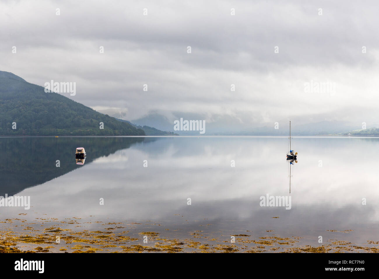 Loch Fyne lies like a mirror in the highlands of Scotland, UK. Stock Photo