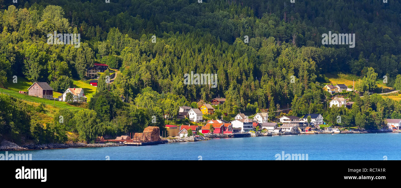 Norwegian village landscape with turquoise fjord water, mountains and ...
