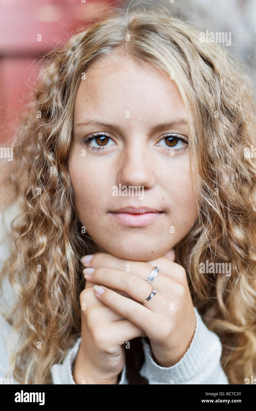 Serious young woman long curly hi-res stock photography and images - Alamy