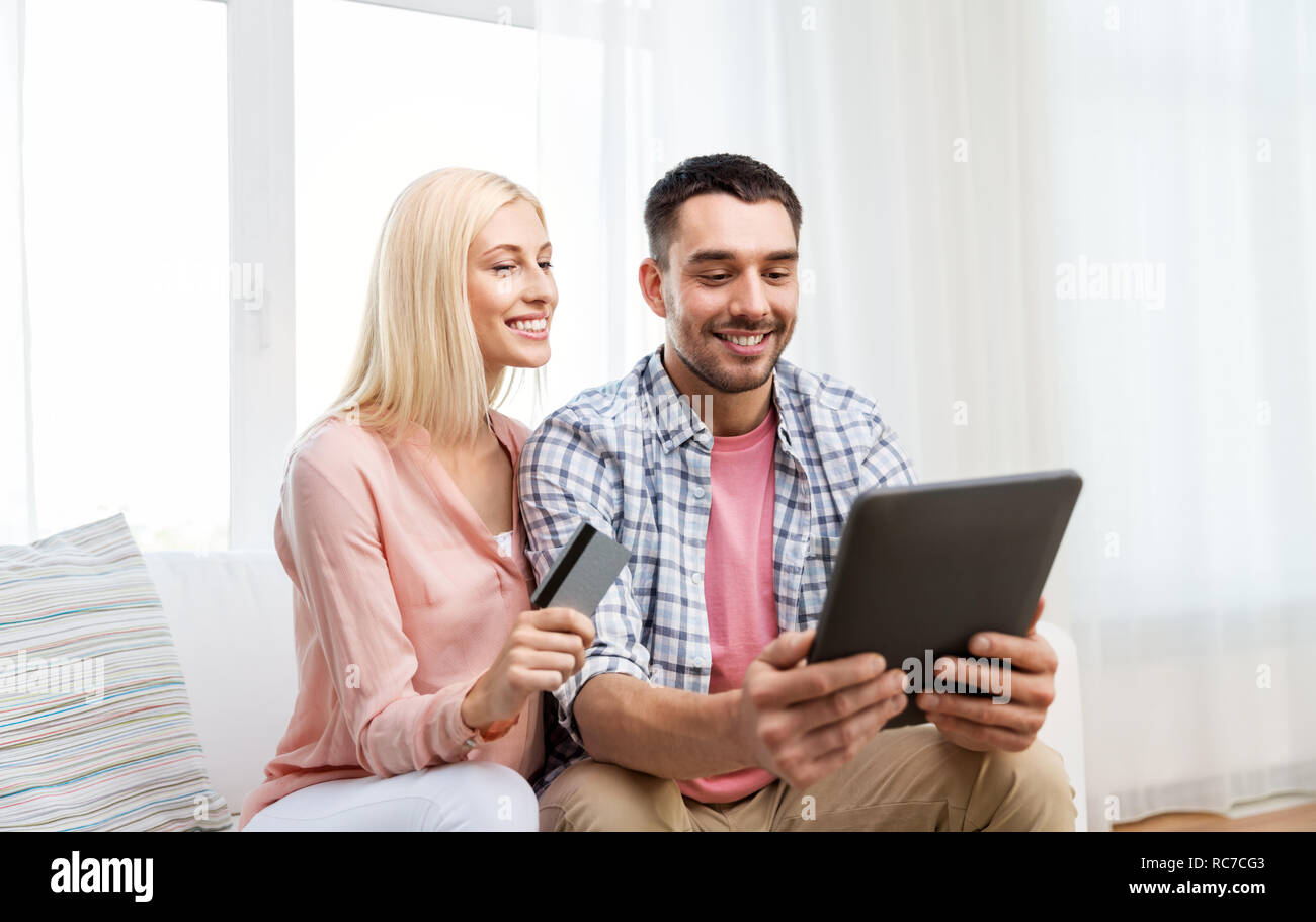 couple with tablet pc and credit card at home Stock Photo