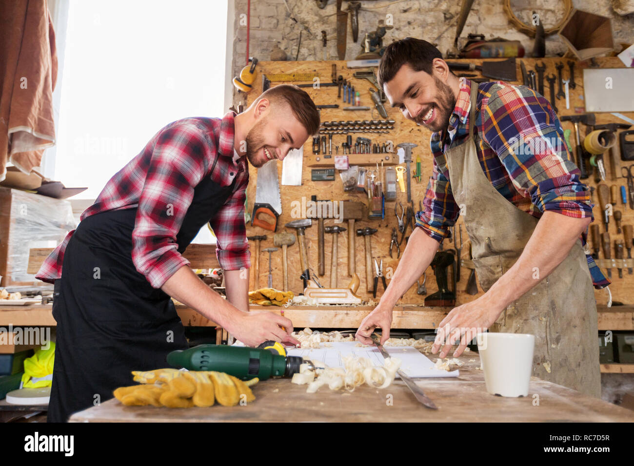 Carpenter Using Ruler carpenters with ruler and blueprint at workshop Stock Photo - Alamy