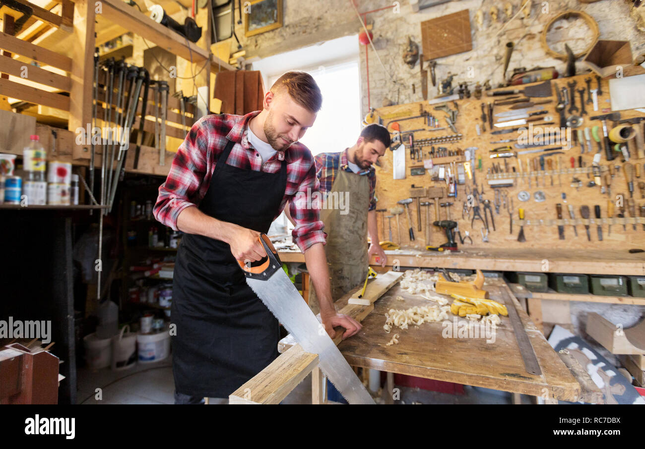 Carpenters Working With Saw And Wood At Workshop Stock Photo Alamy Carpenters Working With Saw And Wood At Workshop Stock Photo Alamy