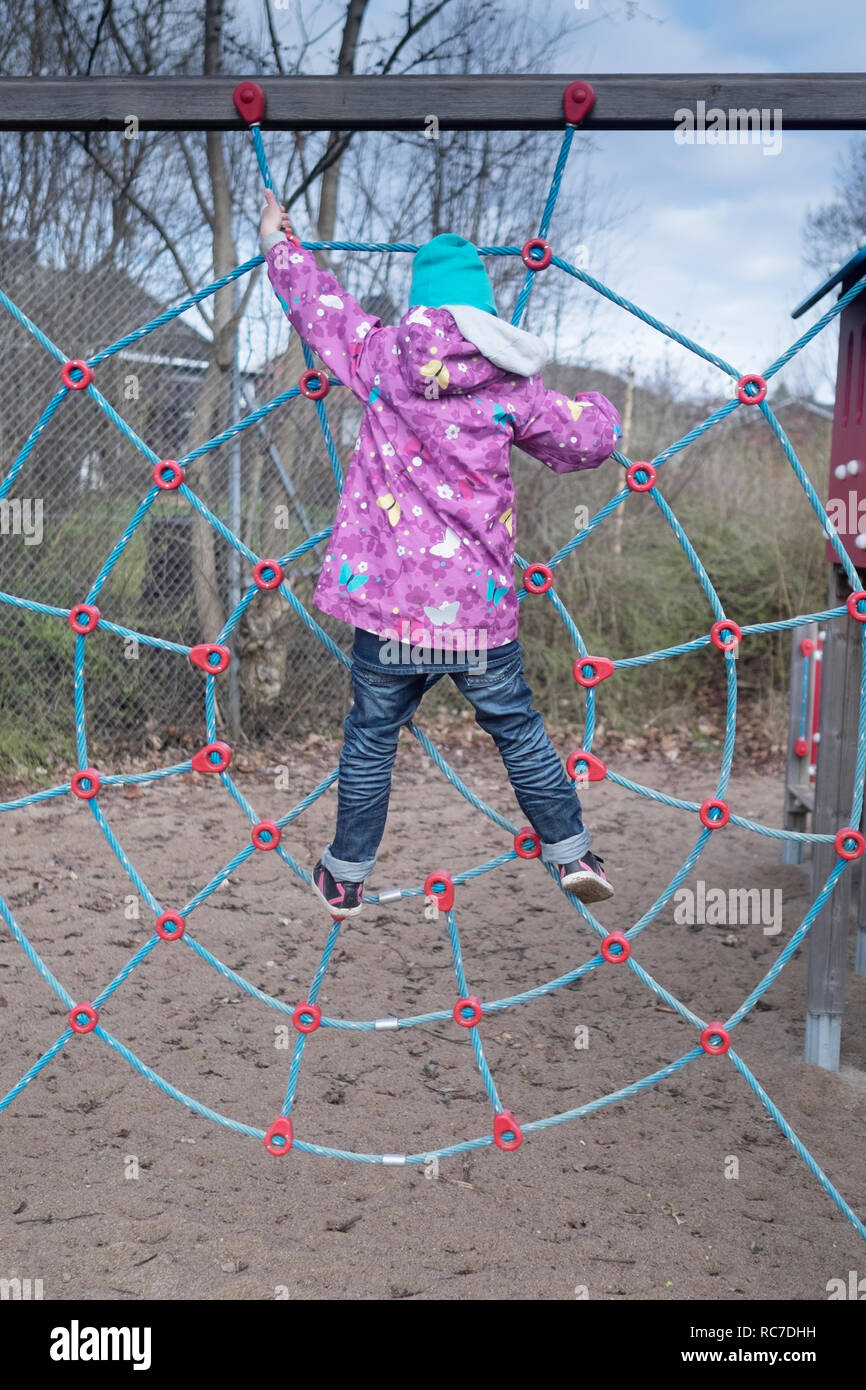 Girl climbing on playground Stock Photo Alamy