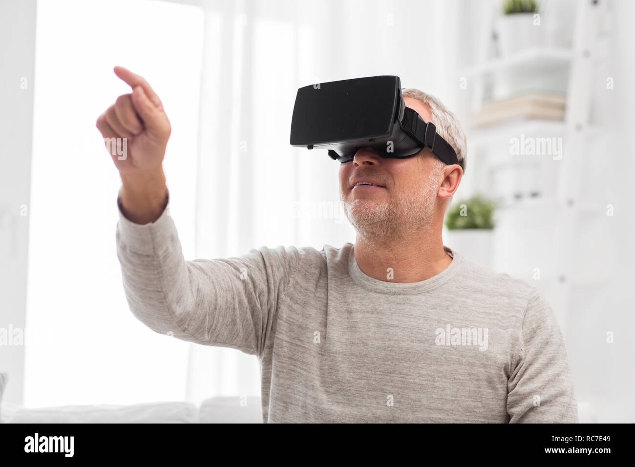 old man in virtual reality headset or 3d glasses Stock Photo