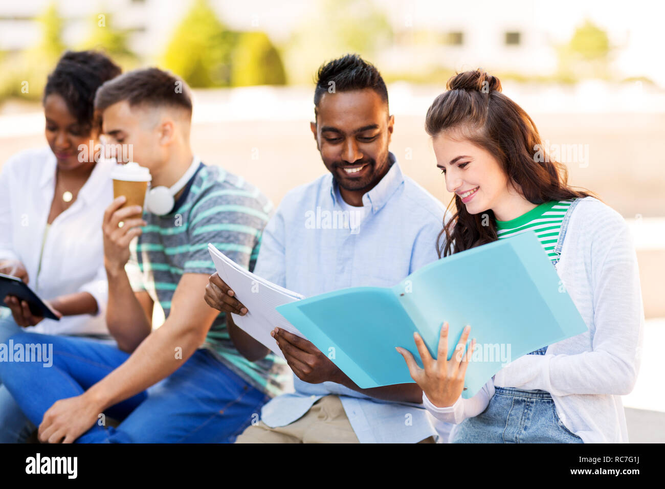 international students with notebooks outdoors Stock Photo