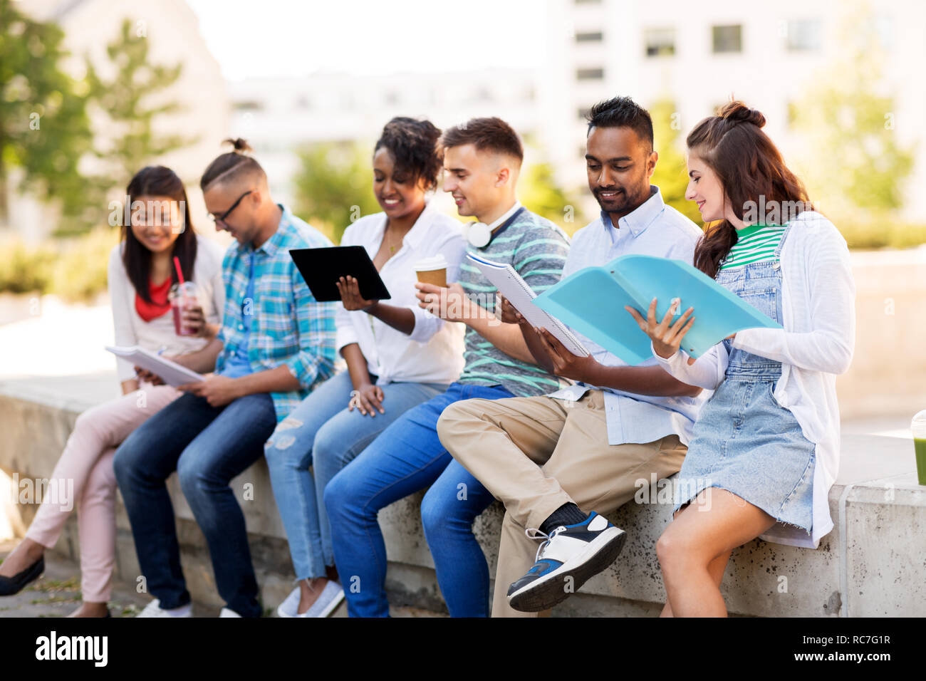 international students with notebooks outdoors Stock Photo