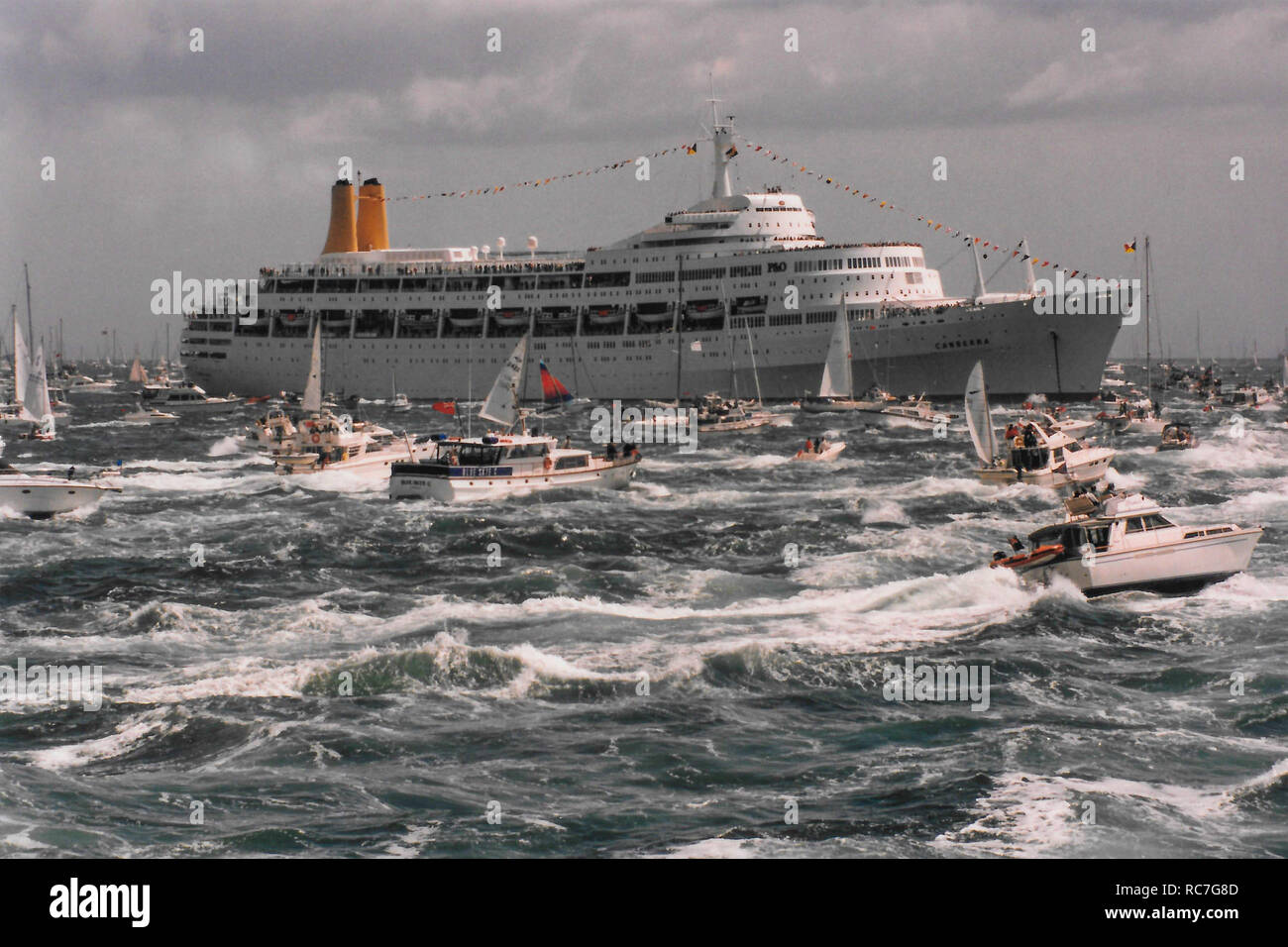 P&O cruise ship Canberra on choppy seas and surrounded by small pleasure craft at the 50th anniversary of D Day at Spithead,off Portsmouth in Hampshire England on 6th June 1994. Stock Photo