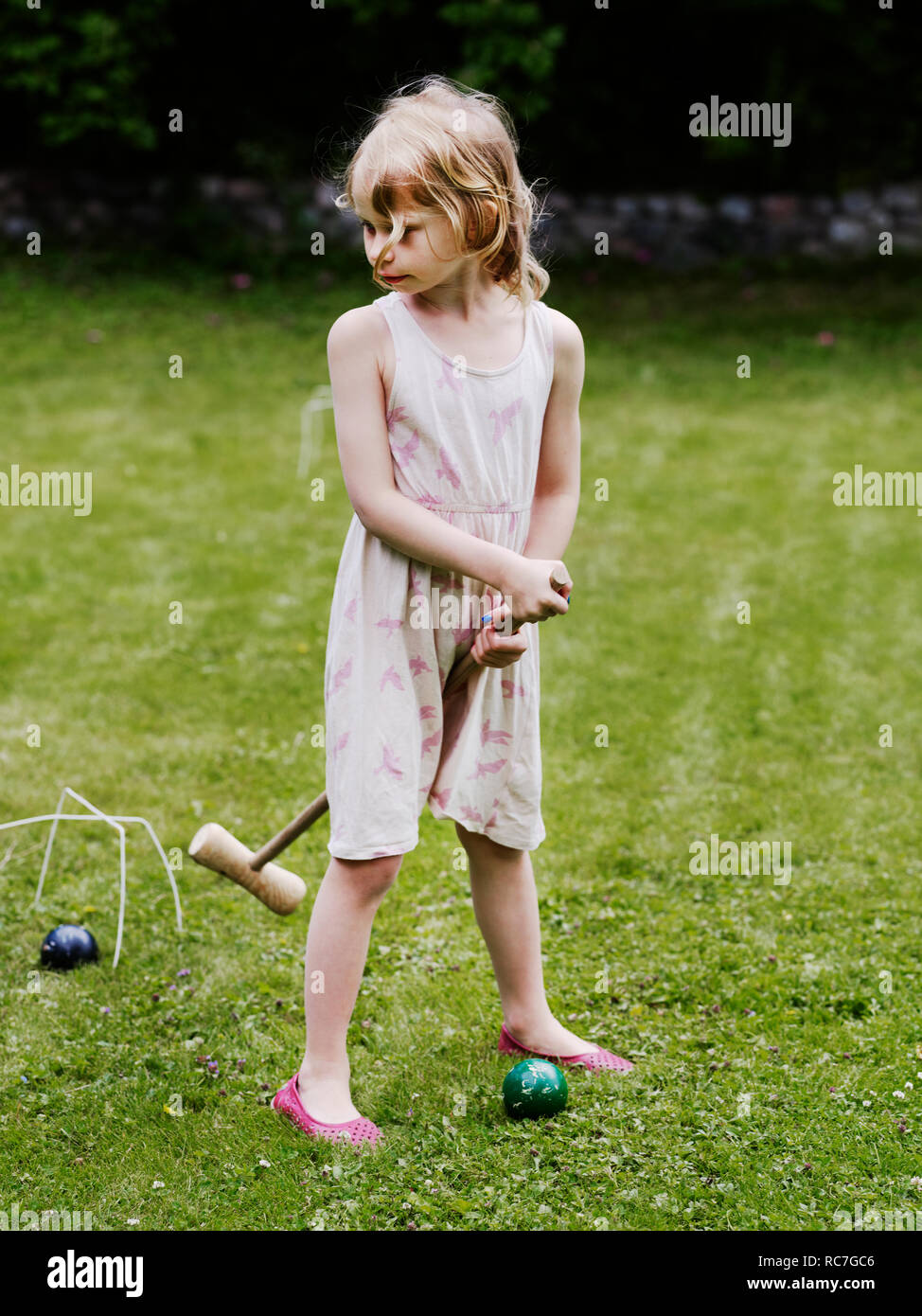 Girl playing croquet in backyard Stock Photo Alamy