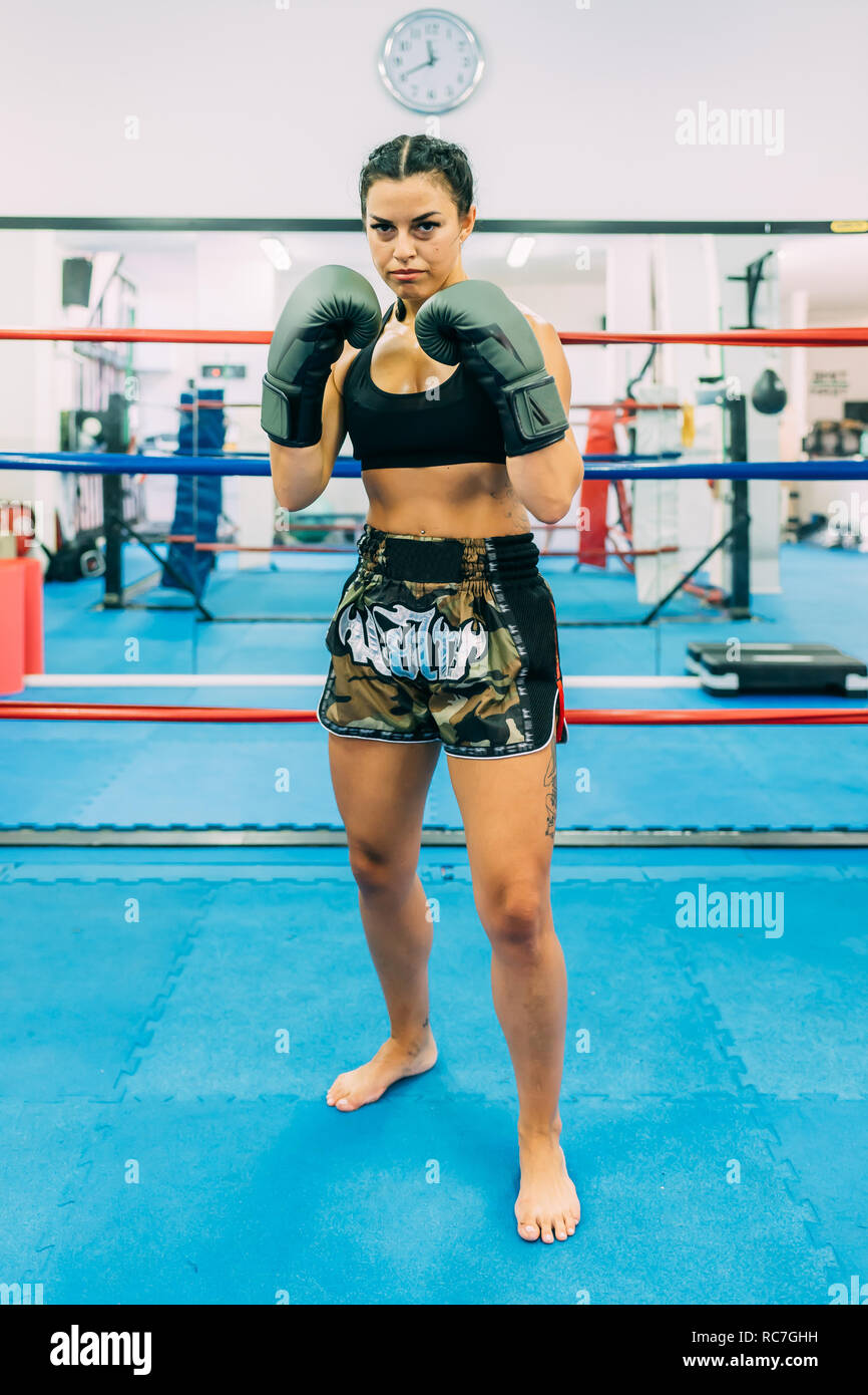 Portrait of female boxer in boxing ring Stock Photo