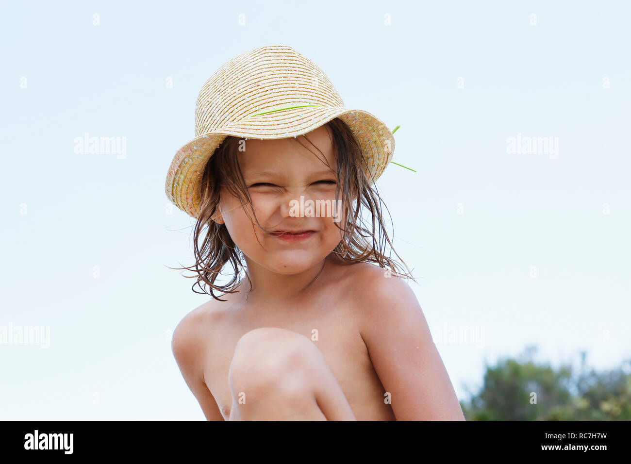 Cute girl in sun hat, portrait, Scopello, Sicily, Italy Stock Photo