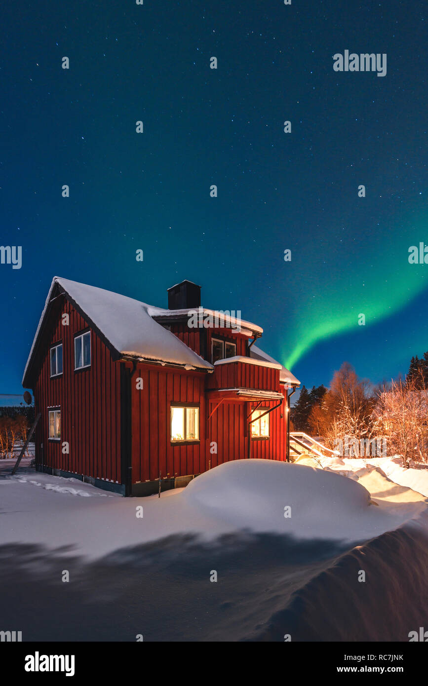 Illuminated house with aurora borealis in background Stock Photo - Alamy