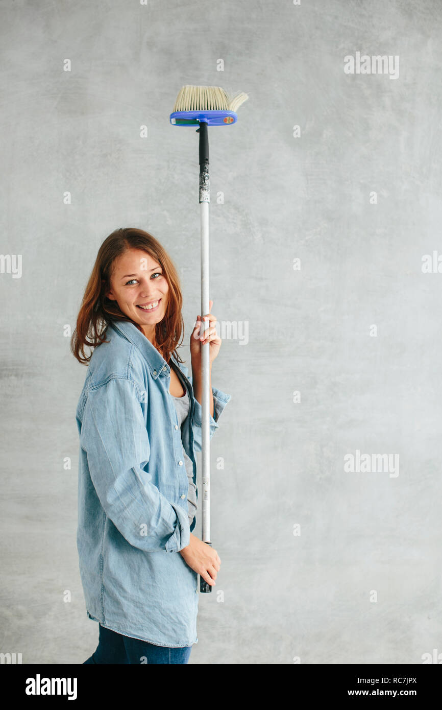 Woman holding brush looking hi-res stock photography and images - Alamy