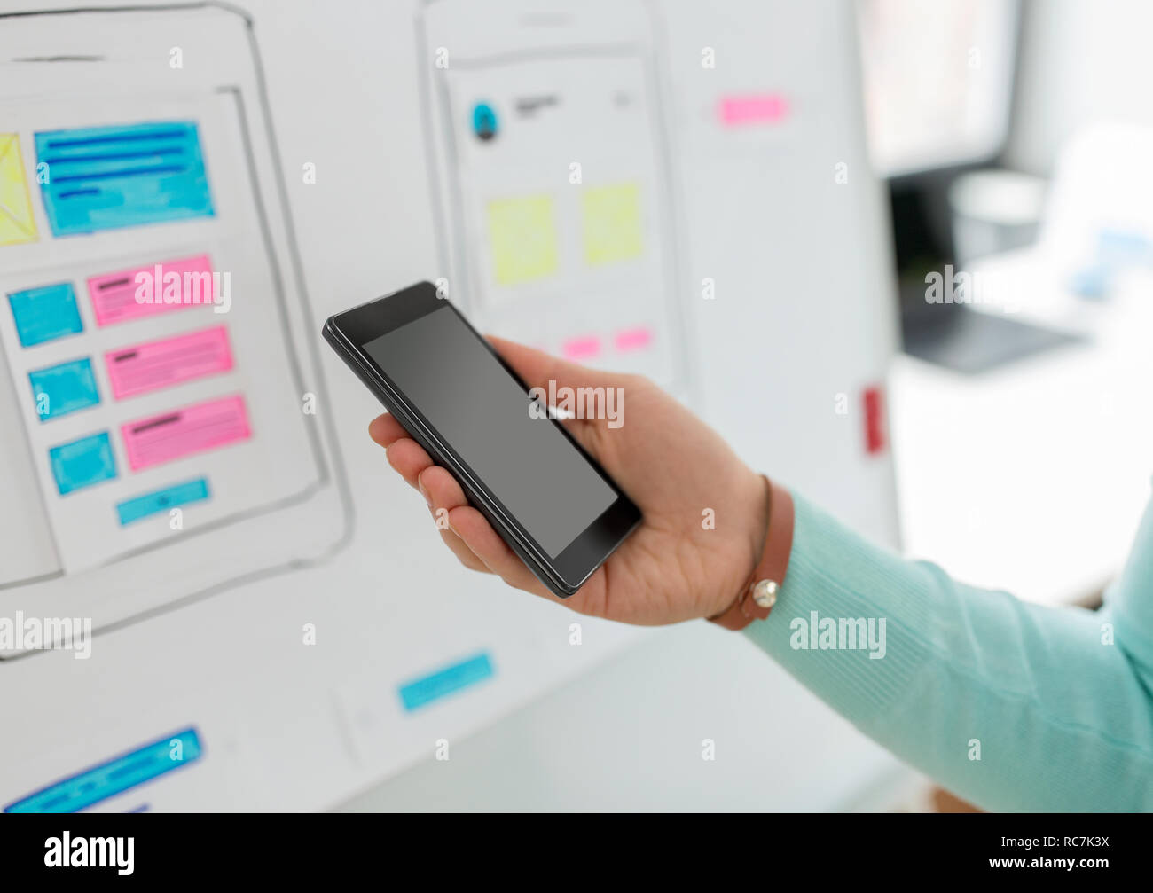 ui designer or developer hand holding smartphone Stock Photo
