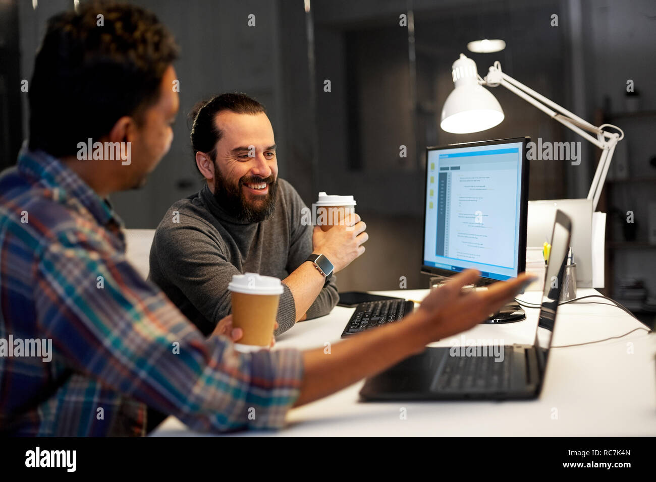 creative team drinking coffee at night office Stock Photo