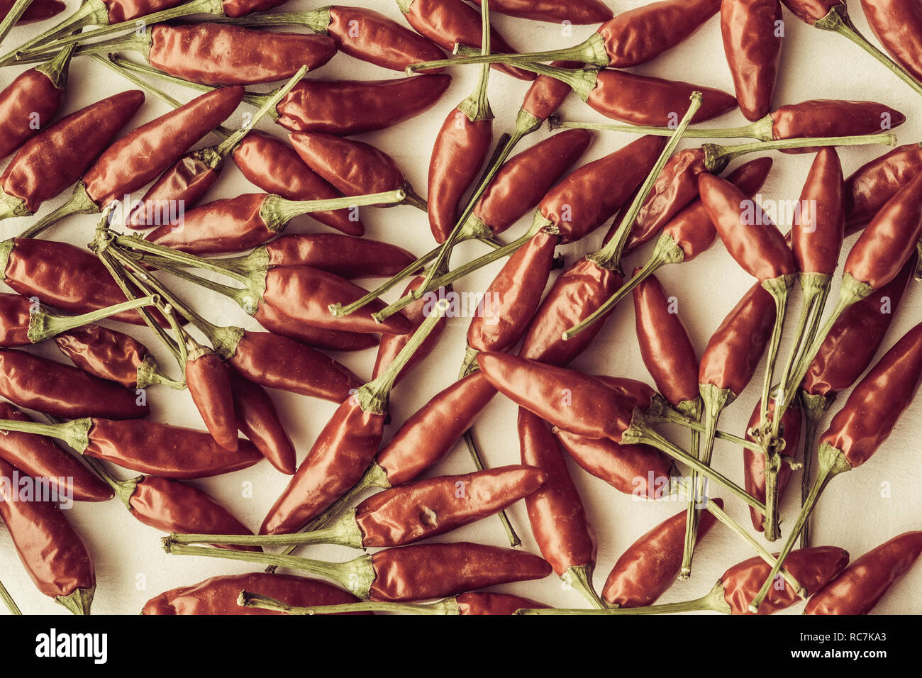 Vintage style shot of a texture of many red hot chili peppers Stock Photo