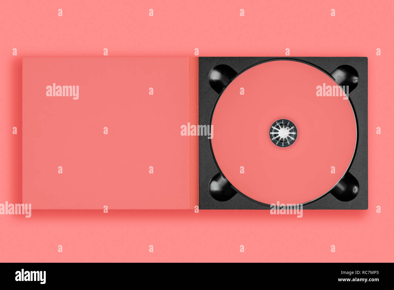 Pastel pink cd in case on pastel pink background. Color of the year 2019 - Living Coral Stock Photo