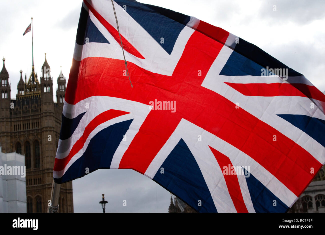 A Union Jack Flag,the flag of Great Britain, flies in front of the Houses of Parliament as Parliament decides if Britain is leaving the EU on March 29. Stock Photo