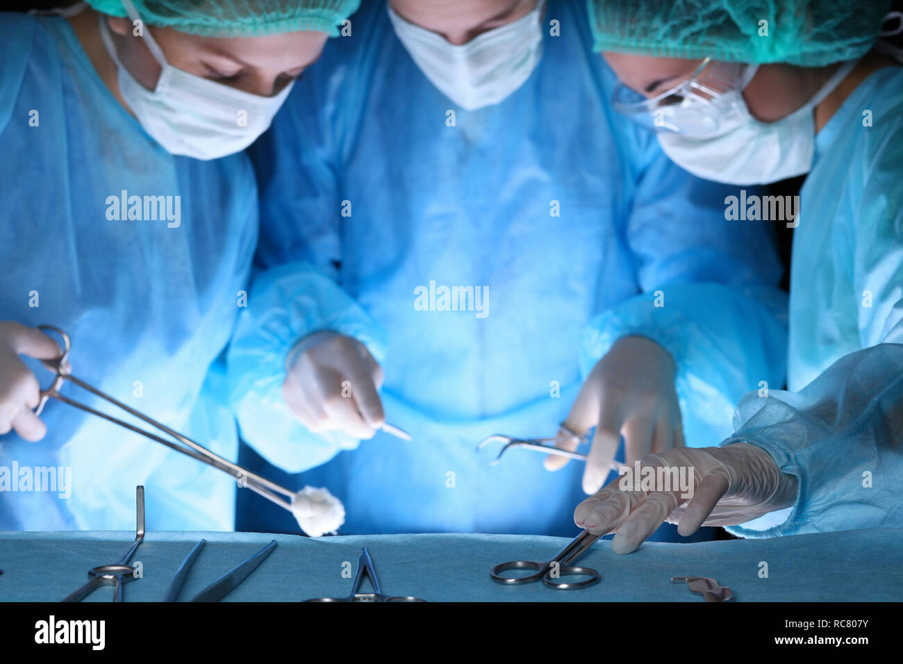 Group of surgeons in masks performing operation. Medicine, surgery and ...