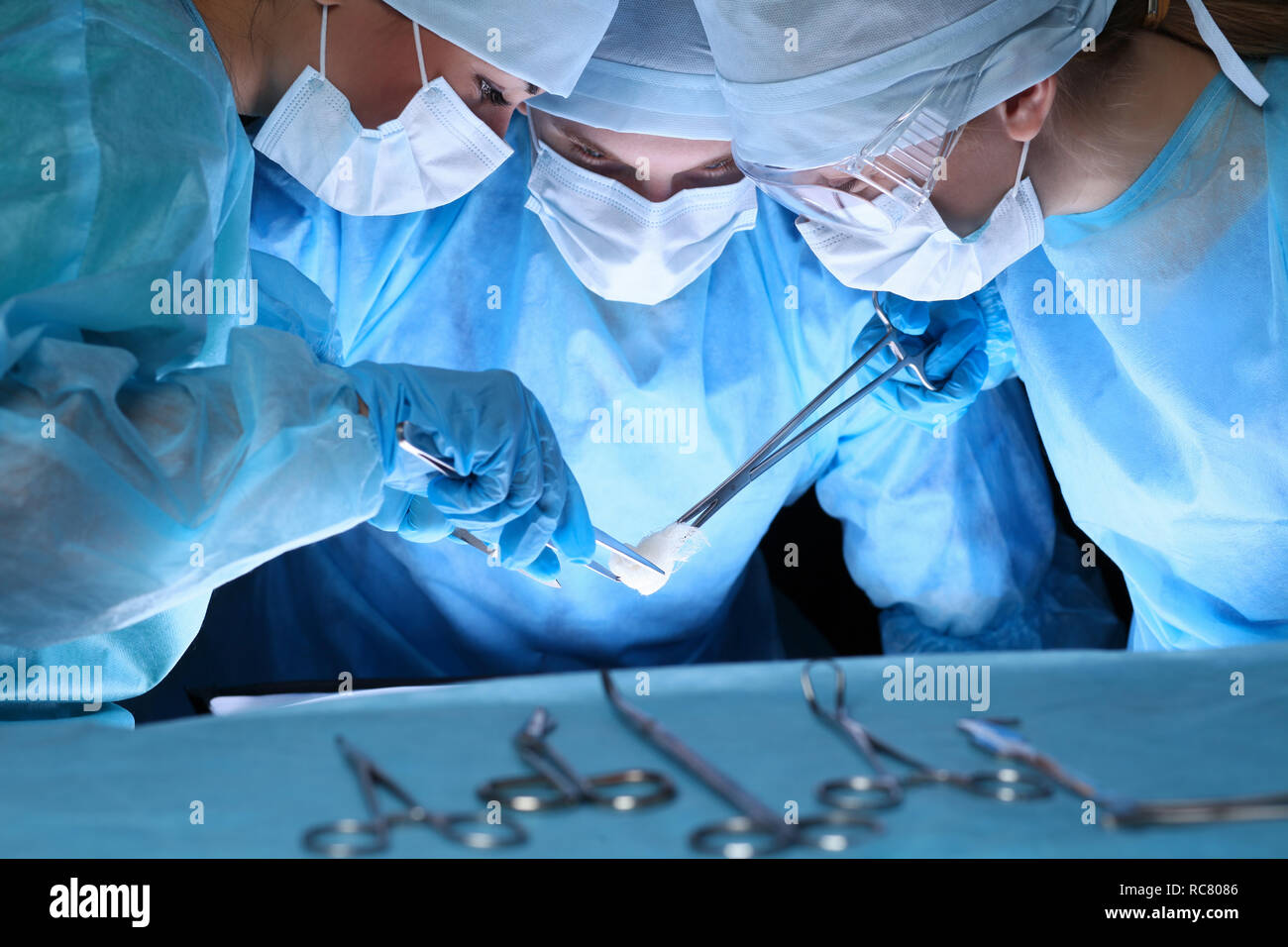 Group of surgeons in masks performing operation. Medicine, surgery and ...