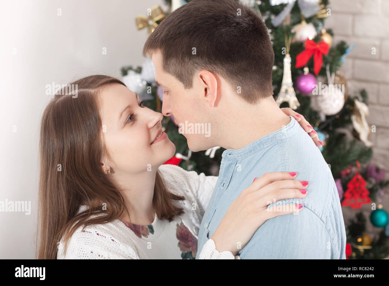 Couple hugging in Christmas time at home Stock Photo