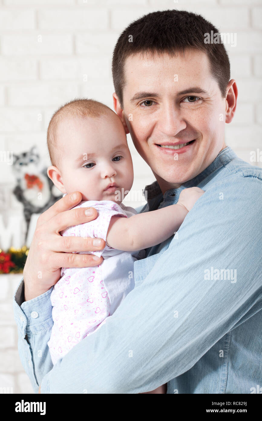 baby with dad. family, parenthood and people concept - father with little baby at home Stock Photo